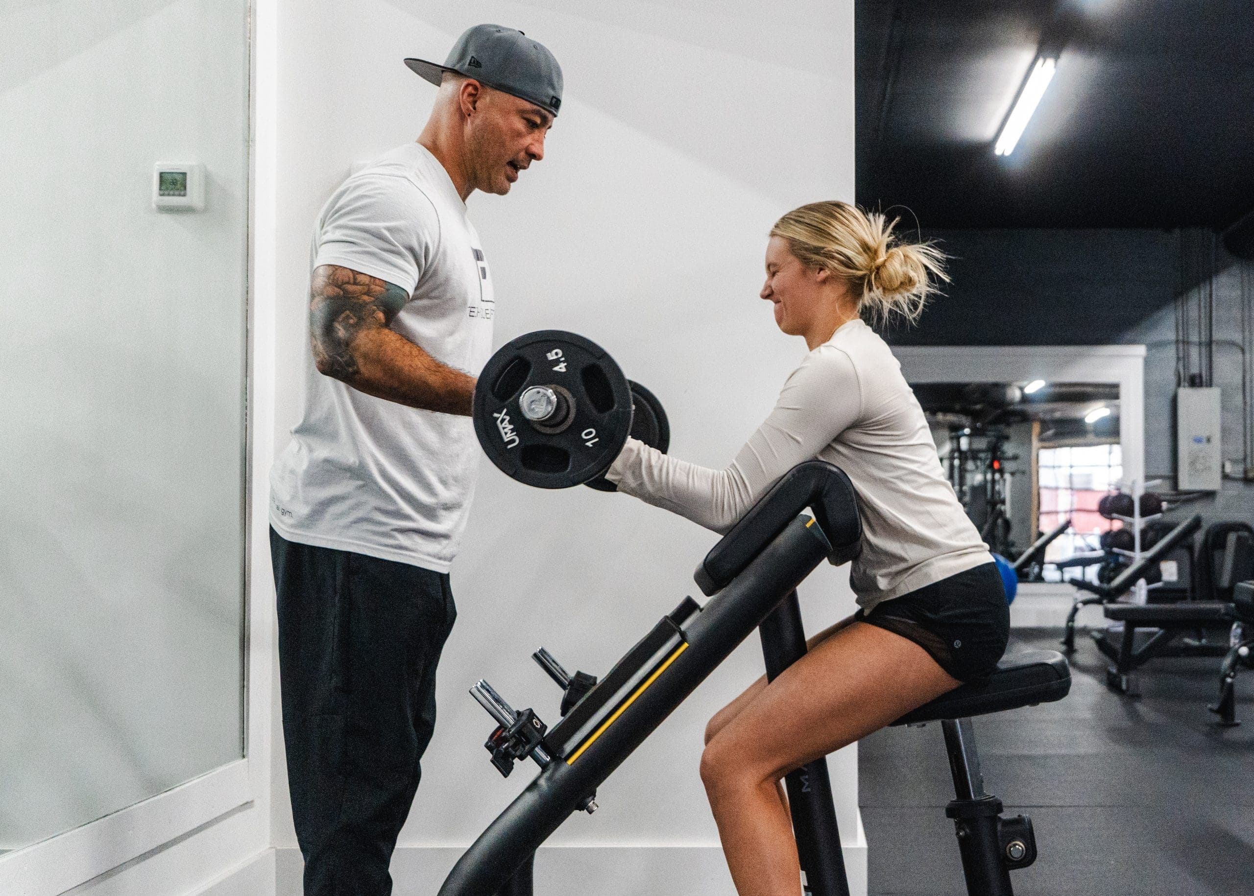 Coach guiding a client through an intro session at Technique Fitness